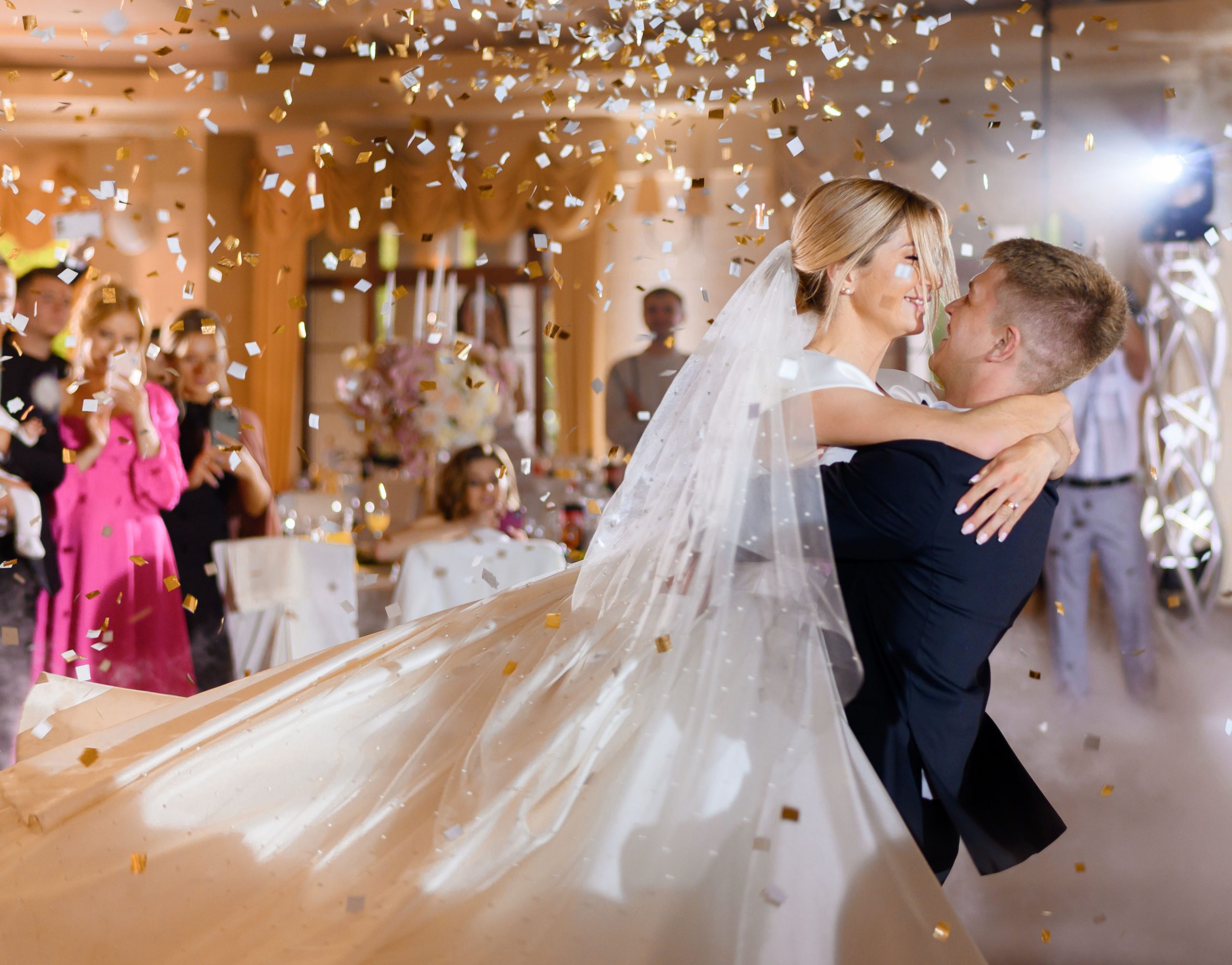 bride couple waving while dacning with confetti copy scaled